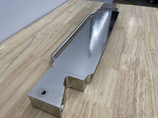 A long polished stainless steel frame machined at RG Manufacturing