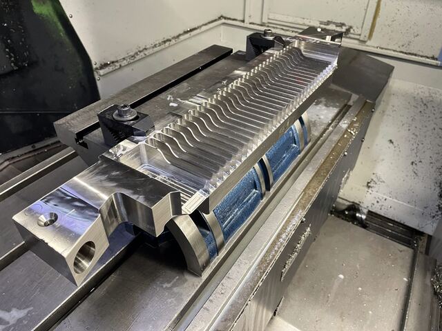 A stainless blade comb being machined on a vertical mill at RG Manufacturing in Rockford, Illinois